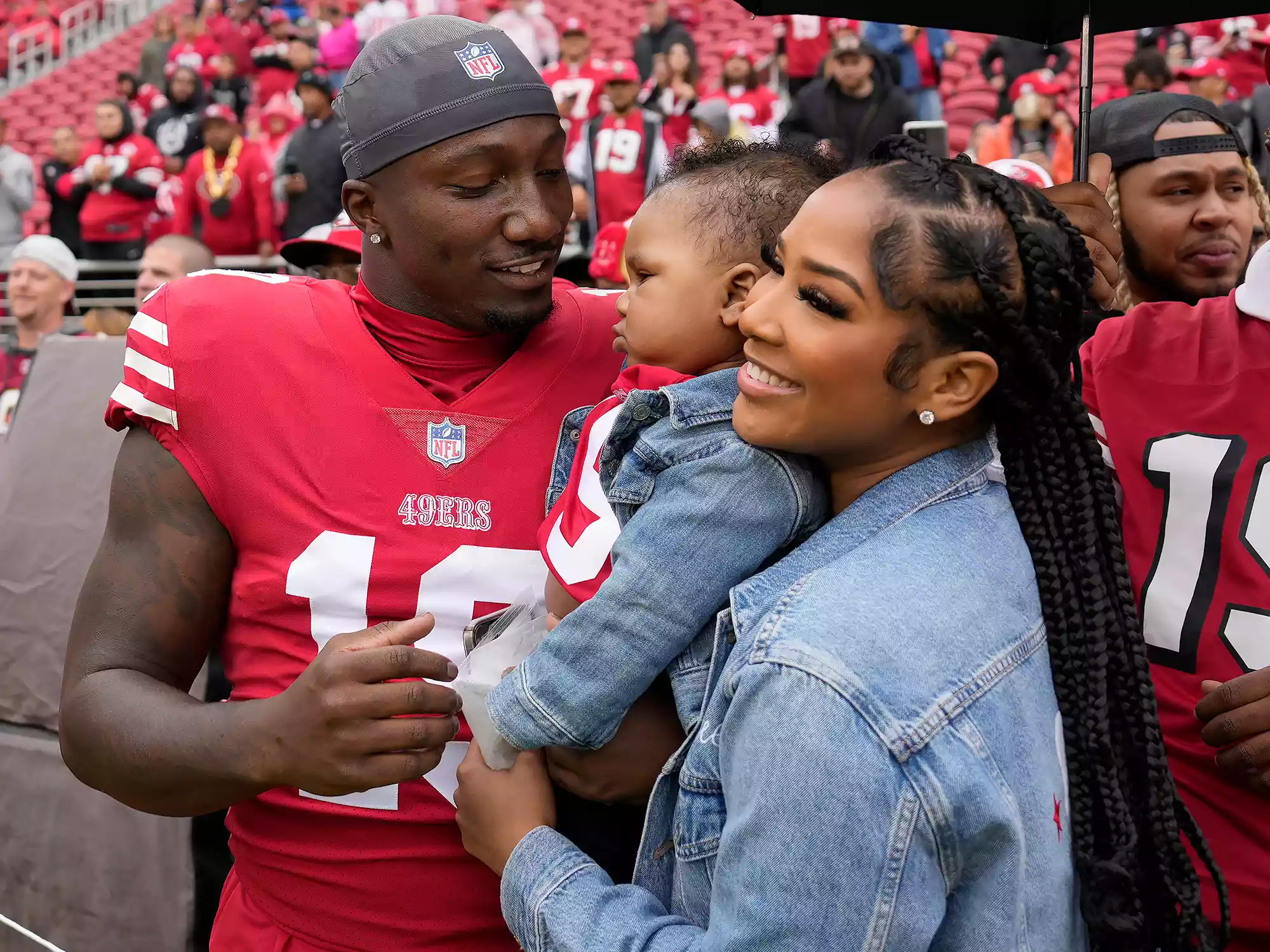 Deebo Samuel, Mahogany Jones, and Tyshun Raequan Samuel Jr. before an NFL football game between the 49ers and the Seattle Seahawks on September 18, 2022.